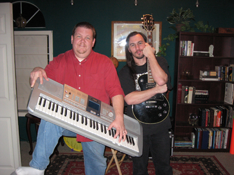 Nathan Stout and Chris McGinty posing with instruments used in season 2 of the public access show according to whim